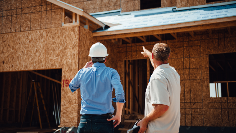 Private Inspector and Builder Reviewing Construction Project